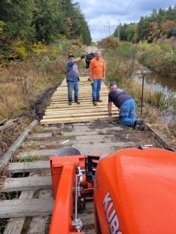 Repairing a bridge on a multi-use trail over water in Rindge, NH