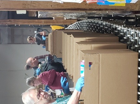 Volunteers pack boxes before distribution