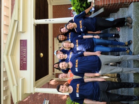 Community Volunteers from Bernstein Shur pose for a photo at TOA's Ocean Street residence, after they completed a day of painting and landscaping activities to beautify the space.