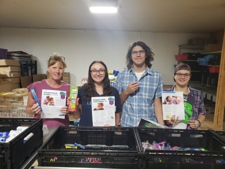 Volunteers create smile packs for area children