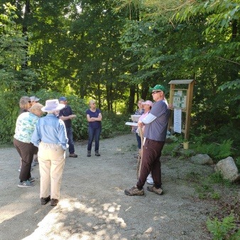 Volunteer hike guides teach people about the importance of grassland and wetland areas.