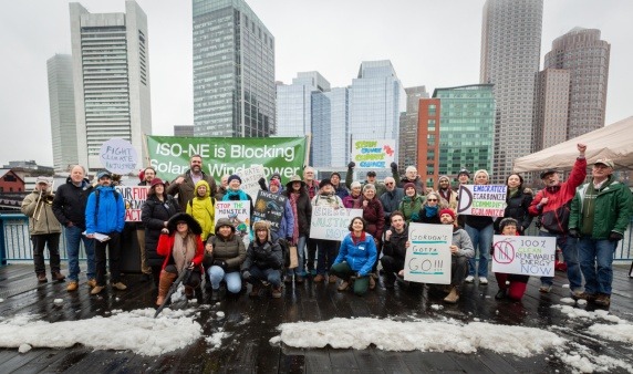 Boston Fee Party rally attendees in front of the Boston skyline