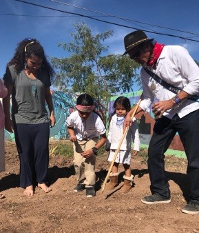 Here is picture of some of the youth and elders working together in planting in the community garden.