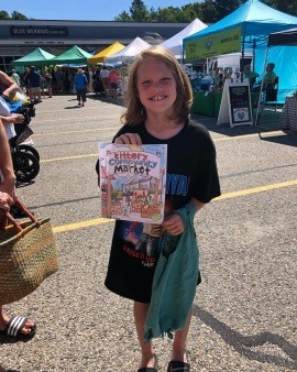 Child engaging in activities at the famer's market