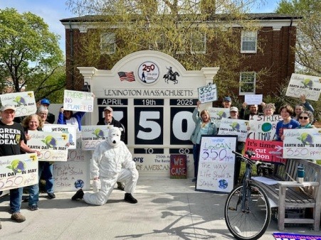A picture showing LexCAN members and activists changing Lexington's 250 clock, which celebrates the 250th anniversary of the battle of Lexington, to a 350 clock, indicating our commitment to getting the atmosphere to 350 ppm of CO2 Equivalent