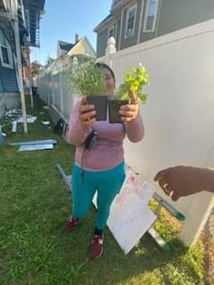 Neighborhood member receiving Free Herbal Plants from our Plant Giveway 