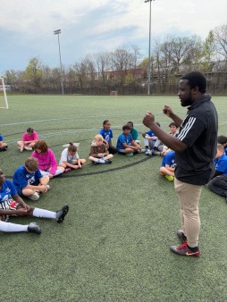Jerry speaking to youth during the soccer camp
