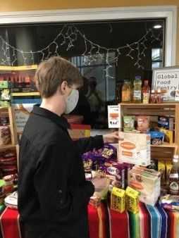 Daily Good co-founder Sandra Neil Wallace stocks the Global Foods Pantry at Keene State College.