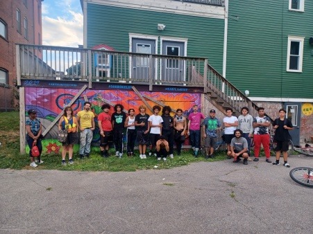 WEAB participants by shop mural