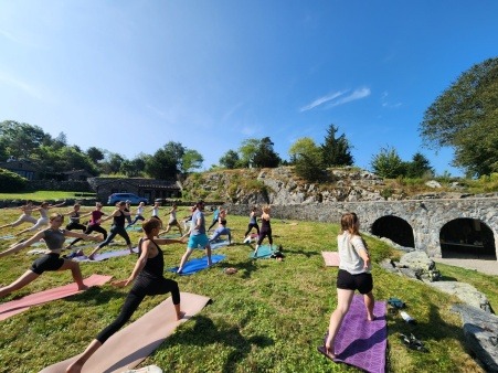 A group of farmers practice yoga on a sunny August day at Ocean Hour Farm in RI