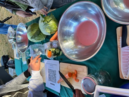 Community food demo learning how to make sauerkraut with fresh produce
