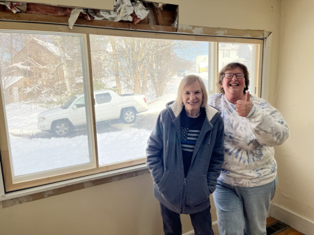 Happy, warmer customer showing off one of her new window inserts