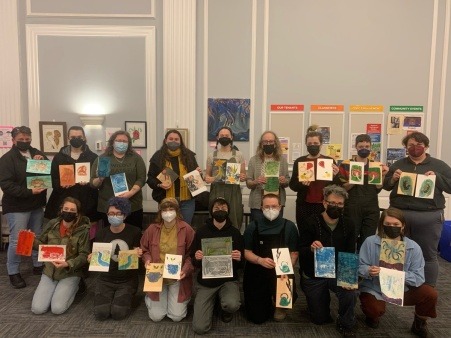This image features 16 workshop attendees at a white line woodblock printing workshop in 2023