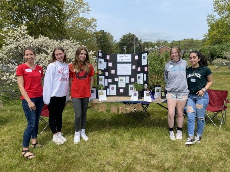 HeRO volunteers share a poster they created for the Ogunquit Native Plant Fair