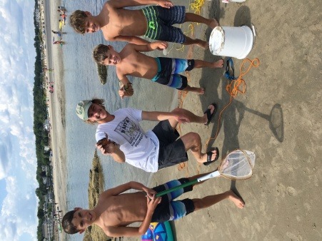 Citizen scientists pose with the crabs they caught for a population survey