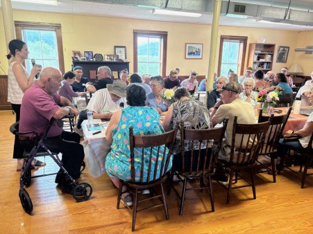 Residents of Snowsville share a community meal Residents of Snowsville share a community meal