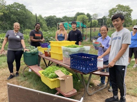 Volunteers packing salad ingredients for a soup kitchen