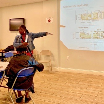 Person presenting a landscape design to a group of people