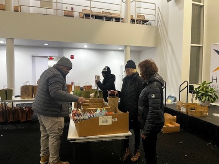Board members and volunteering to help stuff Christmas gift bags.