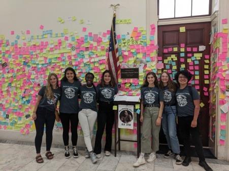 seven From The Ground UP leaders stand in front of AOC's office in D.C.