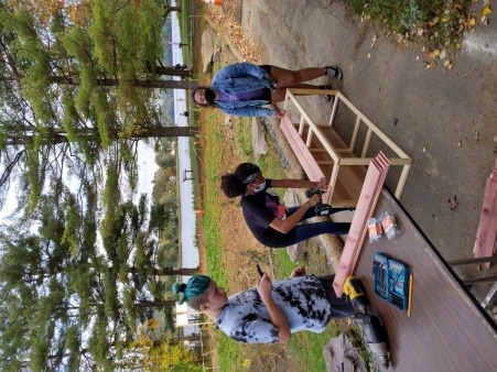 Youth work to construct a planter for the group's alleyway garden