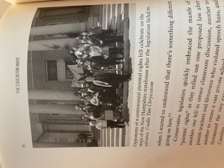 A photo of a page of the book "The Education Wars" - a black and white photo of about 27 trans advocates stand on the steps of the state house. Below, a caption reads, "Opponents of a controversial parental rights bill celebrate on the steps of the New Hampshire statehouse after the legislation failed to advance. Credit: Tim Chrysostom." Below, text reads, "..when I started to understand that there's something different going on here. Conservative legislators quickly embraced the mantle of 'parents' rights'