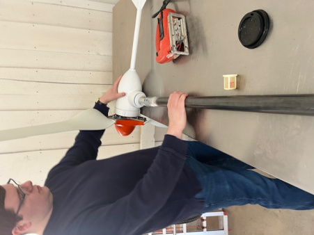 professor McCann readying the microwind turbine to power a vocational workshop lighting