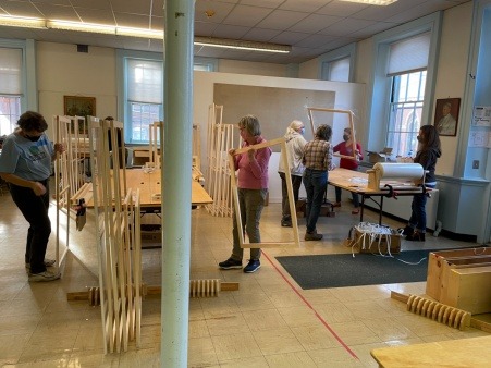 Volunteers assembling inside storm windows, 2021