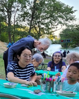 People of all sorts decorating bottle lanterns