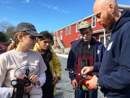 NECWA interns and staff being taught how to use a marine radio for rescue work