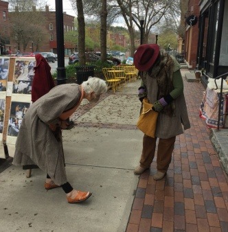 two women appreciate a naturally dyed 100% local wool bag