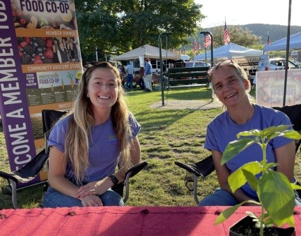 Androscoggin Food Co-op volunteers at info booth during Farmers Market