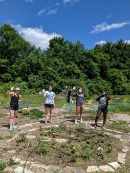 Four From The Ground UP leaders stand in the community garden they are planting