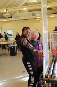 Two women holding a window insert