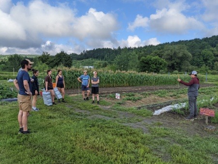 Middle schoolers, high schoolers, and some community volunteers gather for a day of volunteering at the community FEAST farm. 
