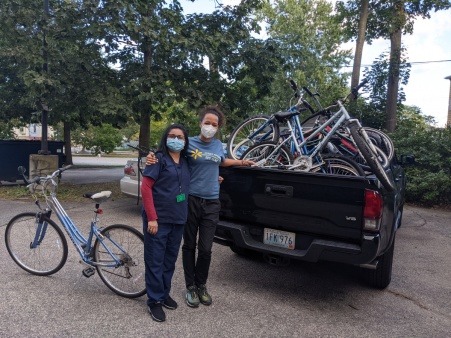 Two nurses from Clinica Esperanza, a local clinic for undocumented folks, pick up a truckload of bikes to redistribute to clients.
