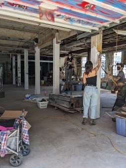 volunteers paint the arch st warehouse
