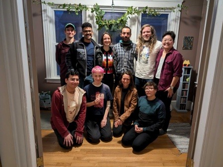 a group of about ten people smile at the camera