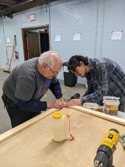 Community volunteers building inserts