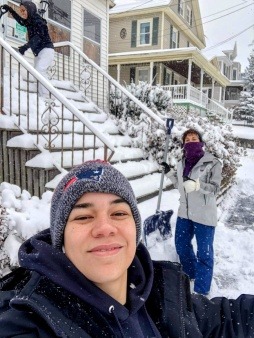 Operation Rosebud volunteer shoveling snow