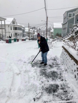 Operation Rosebud volunteer shoveling snow