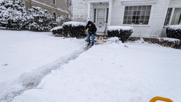 Operation Rosebud volunteer shoveling snow