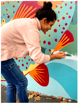 A member of the ArtLords painting the High Street Mural, organized by Epsilon Spires