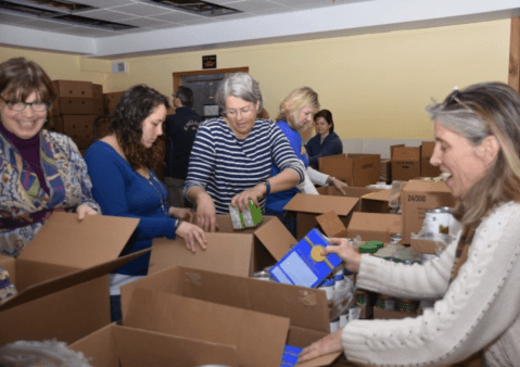 MUCH volunteers prepare boxes