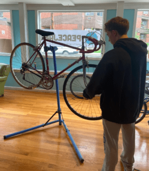 Student works on repairing a donated bike.