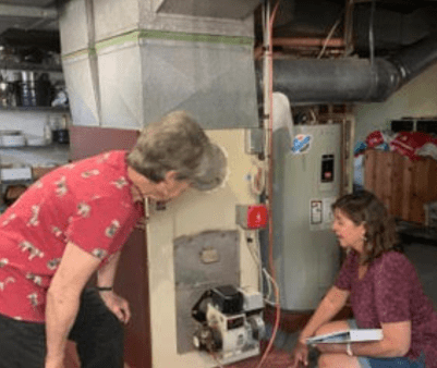 Coach and client evaluate a heating system