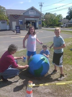 Painting local grocery store traffic barriers to represent the Earth