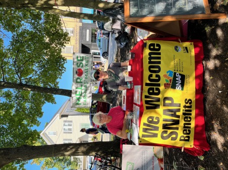 SNAP benefits table volunteers staffing the SNAP Match table at the market