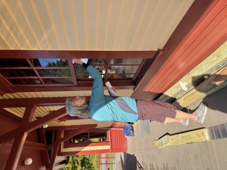 Volunteer washing windows at the train station trailhead.