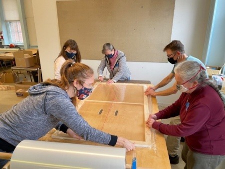 Volunteers wrapping an insert at our 2021 build